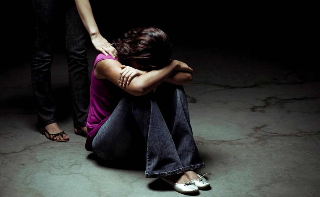 Person in distress receiving compassionate support during difficult moment